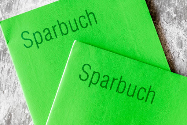 istock Closeup with two old-fashioned passbooks with green cardboard pages. 1453645158