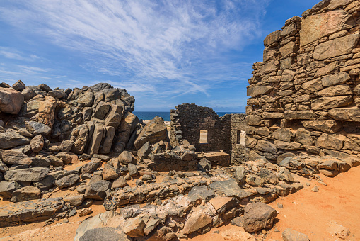 Beautiful historical view of Caribbean coast with ruins of gold smelter in Bushiribana. Aruba island.