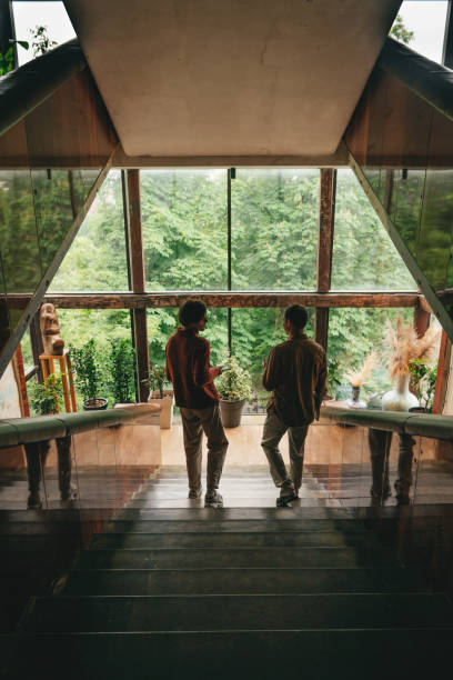 Two colleagues talking in office on the stairs windows