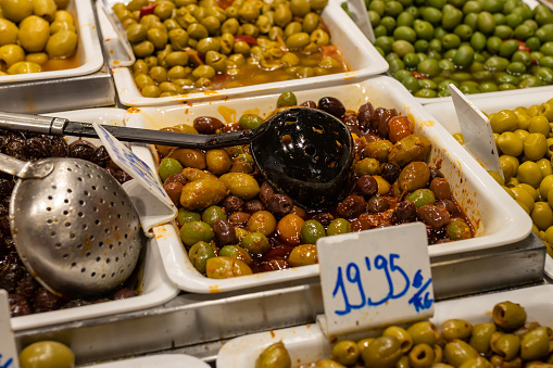 Different types of seasoned olives at a market in Seville (Spain).