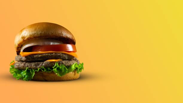 istock Tasty hamburger on an orange background with a copy space 1453646303