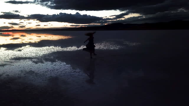 modern ballet dancer dancing on the sea sunset