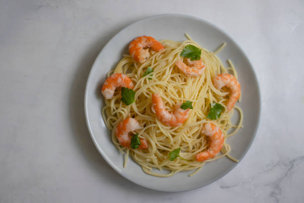 istock Spaghetti with shrimps in a plate on background 1453647719