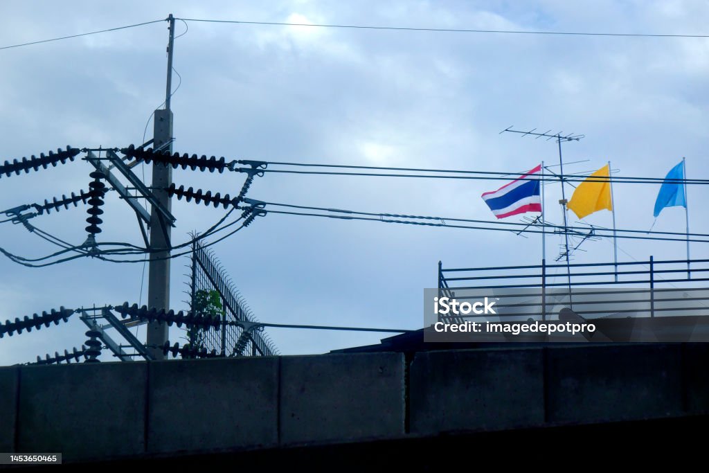 Thai flag and electricity power lines Detail from Bangkok street Amperage Stock Photo