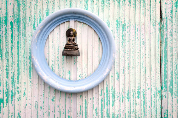 istock Small Buddha sculpture on building exterior wall 1453650505