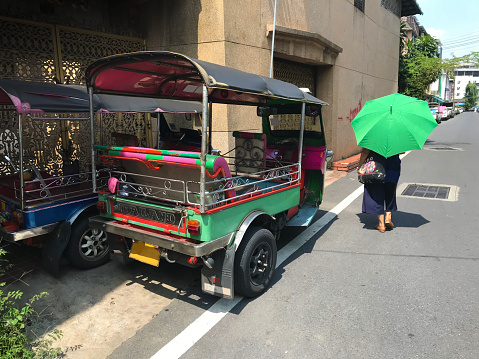 City street with colorful cute Tuk Tuk taxi in Bangkok, Thailand