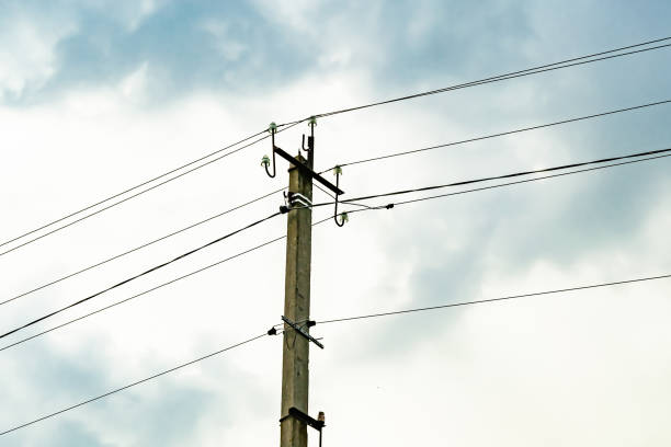 istock Power electric pole with line wire on colored background close up 1453651721
