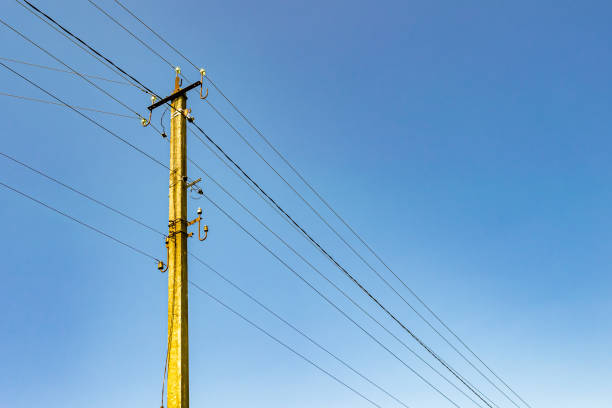 istock Power electric pole with line wire on colored background close up 1453651761