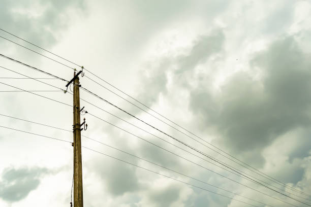 istock Power electric pole with line wire on colored background close up 1453651811