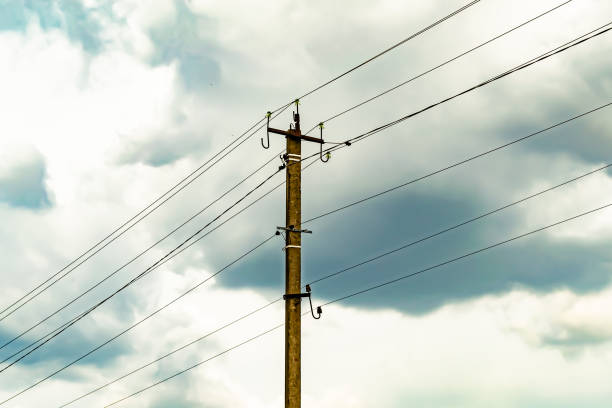 istock Power electric pole with line wire on colored background close up 1453651891