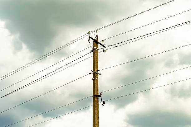 istock Power electric pole with line wire on colored background close up 1453651896