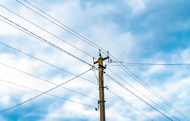 istock Power electric pole with line wire on colored background close up 1453652464