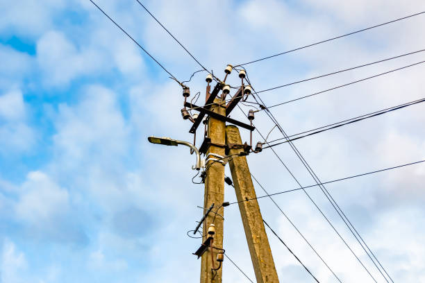 istock Power electric pole with line wire on colored background close up 1453652473