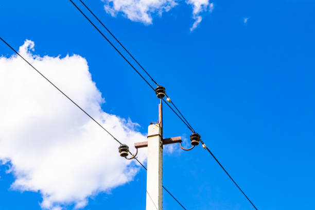 istock Power electric pole with line wire on colored background close up 1453652533