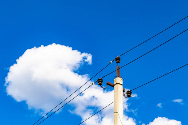 istock Power electric pole with line wire on colored background close up 1453652540
