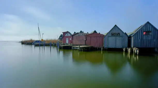 Small fishing and tourist harbour with boathouses in the inland harbour on the Bodden