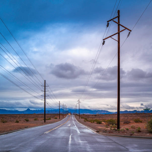 istock Electricity pylons and cables with stormy clouds 1453657574