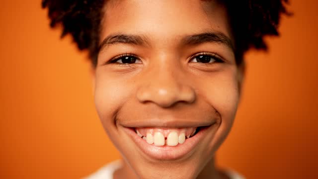 Portrait of a boy on an orange background