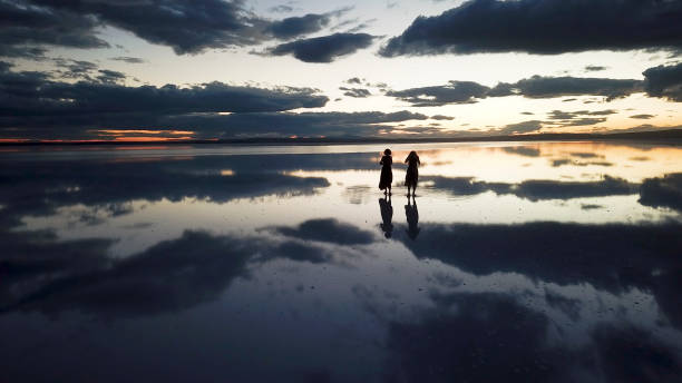 istock Young ballerinas dancing on the the sea sunset 1453661207