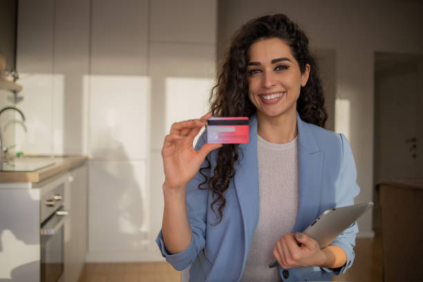 istock Cheerful  woman doing online shopping 1453662227