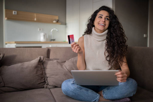 istock Cheerful  woman doing online shopping 1453662233