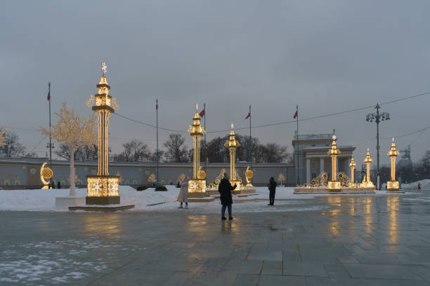 Moscow public park is decorated to the New Year holidays, people walk here stock photo