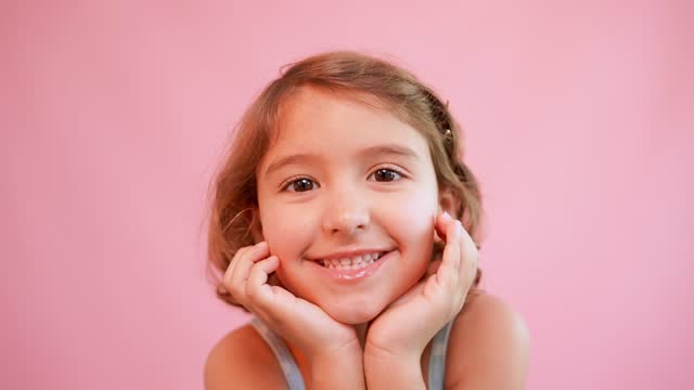 Portrait of a girl on a pink background