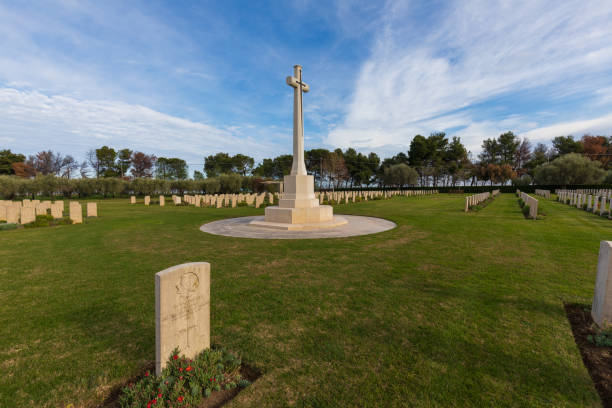 The Canadian military cemetery. Italy donated the land on which the cemetery stands in order to thank and honour the ultimate sacrifice of the British Commonwealth troops, mostly Canadians who fought for the liberation of Italy from fascist and Nazi horror. canada flag blue sky clouds stock pictures, royalty-free photos & images