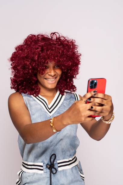 istock pretty african lady using her phone 1453666571