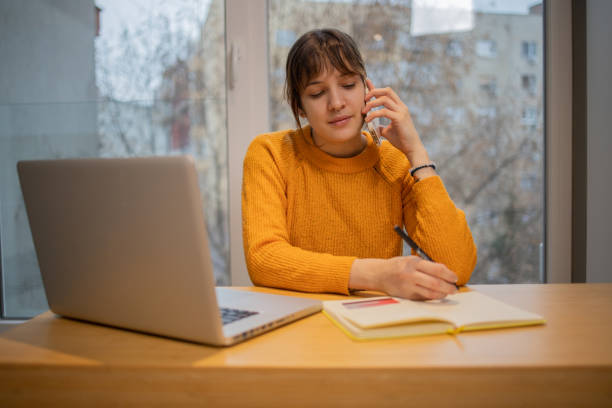 istock Young woman working from home 1453667289