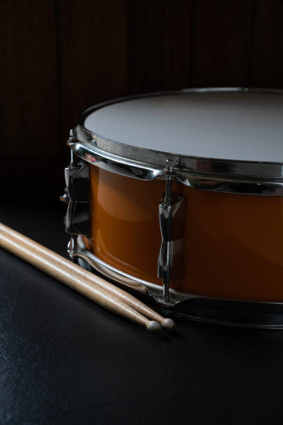 istock Drum stick and drum on black table background, music instrument concept 1453670043