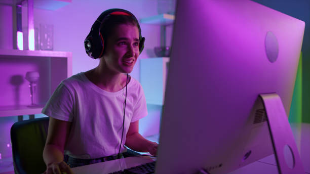 istock Cyber streamer talking online with team closeup. Neon joyful player in headset 1453670861