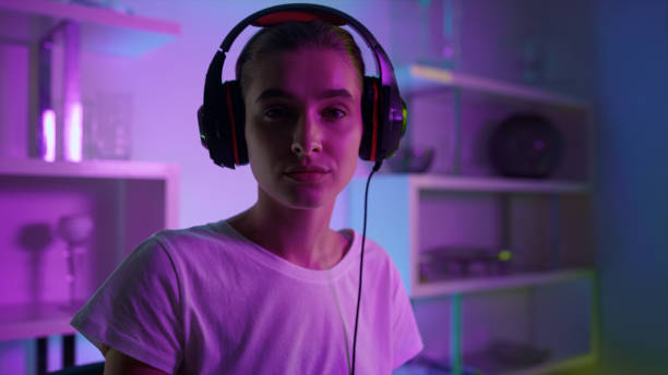 istock Focused esport player looking camera closeup. Professional streamer in neon room 1453670864