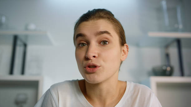 istock Closeup girl making video call talking with family at home. Web camera view. 1453672343