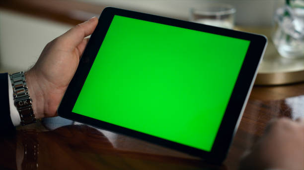 istock Closeup mockup tablet computer in man hands. Businessman hold green screen pad 1453674116