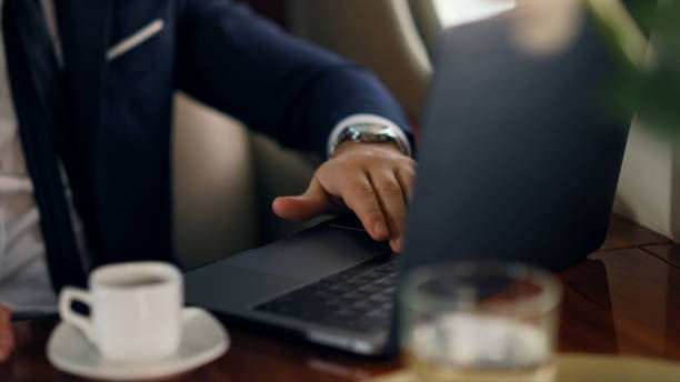 man starting online call on business jet. closeup businessman hand waving laptop - tap airplane imagens e fotografias de stock