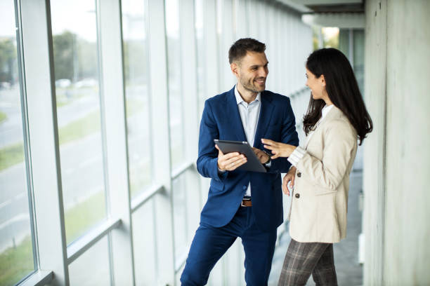 istock Business people making agreement in a hallway and talking 1453676904