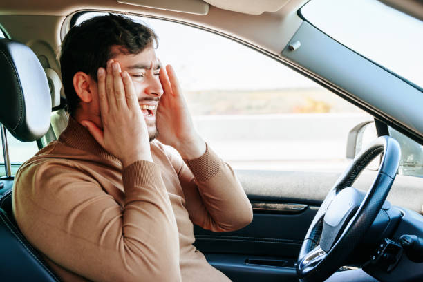 istock A migraine and a headache prevent a young man with a beard from driving. 1453676957