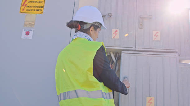istock Female engineer working in solar power plant. Solar city. 1453678251
