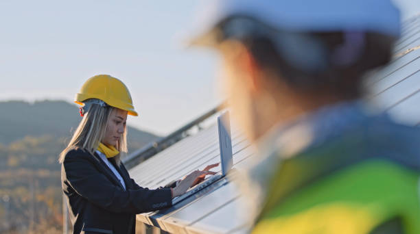 istock Female engineers working in solar power plant. Solar city. 1453678255