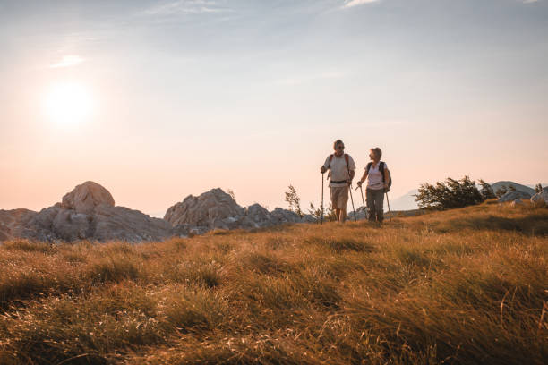 istock Senior Couple Talking And Bonding Over A Romantic Outdoors Hike 1453678290