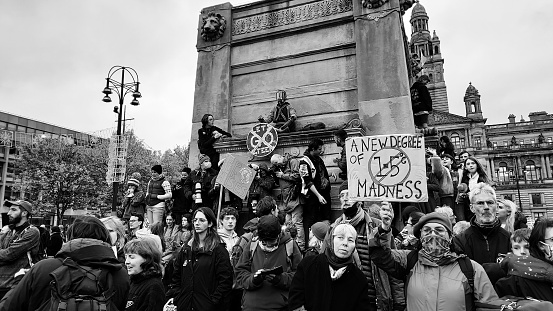 GLASGOW, United Kingdom – October 28, 2021: A view of group of people during COP26 protest in black and white in Glasgow