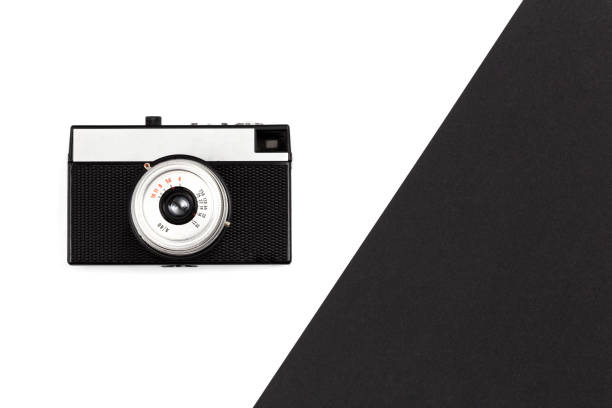 istock Old film camera on a black and white background, flat lay. 1453687598