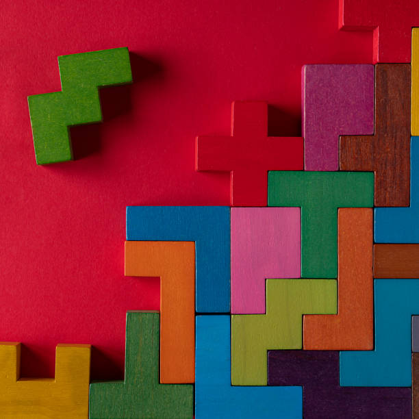 istock Top view on colorful wooden blocks folding on red background 1453687601