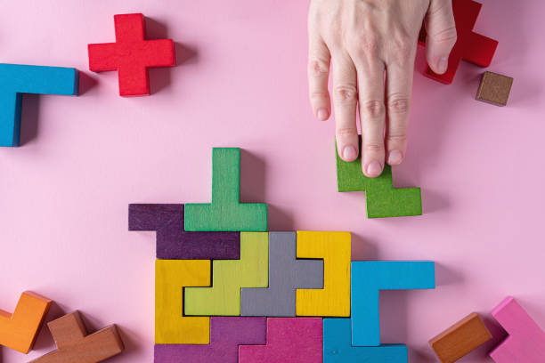 istock Different colorful shapes wooden blocks on pink background 1453687604