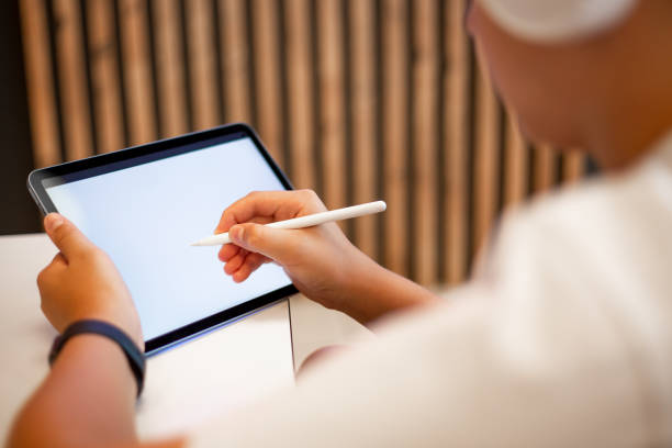 istock Teenage boy drawing on digital tablet 1453687955