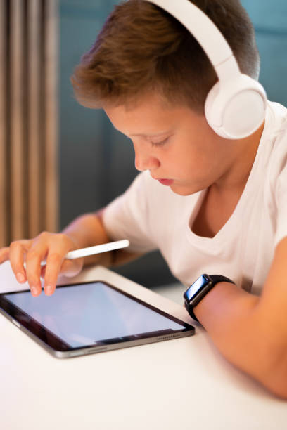 istock Teenage boy drawing on digital tablet 1453688892