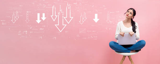 istock Descending arrows with woman using a laptop 1453690655