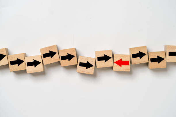 istock Red arrow move in opposite direction from black down arrow for business disruption and leadership concept. 1453695751