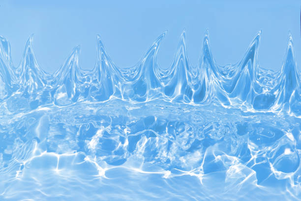 istock Defocus blurred transparent blue colored clear calm water surface texture with splashes and bubbles. Trendy abstract nature background. Water waves in sunlight with caustics. Blue water spay shinning 1453697584